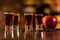 Alkohol shots coffee beans and apple on bar table on blurred background