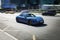 all-electric car Porsche Taycan in motion. Speeding in city road concept