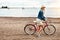 All geared up and ready to start paddling. Portrait of a cheerful young woman getting ready to ride her bicycle while