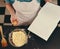 So all I need is just one egg. an unrecognizable woman reading a recipe from a book while baking at home.