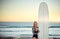 All I need is my surfboard. Cropped portrait of an attractive young female surfer standing with her surfboard on the