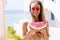 All Inclusive Cheap Summer Holidays. Young Happy Woman with Watermelon and pink sunglasses at beach Background. Summertime fun