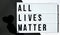 ALL LIVES MATTER text with deep shadows of heart on a black and white background. Protest against the end of racism, anti-racism,