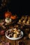 All Saints Day marzipan sweet panellets and roasted chestnuts, autumn leaves on wooden table