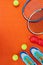 Are we all set. High angle shot of tennis essentials placed on top of an orange background inside of a studio.