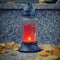 All Souls\\\' Day. A lit candle on the grave. Background with cemetery. Soulstice - remembrance of the dead - Halloween.