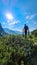 Allakogel - Hiker man on hiking trail in dense alpine forest with scenic view of majestic mountains of Hochschwab