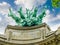 Allegorical statue over facade of Great Palace closeup in Paris