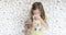 An allergic child sneezes into a handkerchief. Symptoms of influenza and the common cold in primary school children. Girl with a