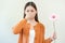 Allergic rhinitis symptom of odor pollen flowering, portrait asian young woman hand in sneeze, blowing runny nose after smell,