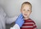 An allergist or dermatologist examines red spots on a childâ€™s face. The boy suffers from a rash, hives and itching. Food Allergy