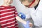 An allergist doctor makes a skin test for allergies. The boy is being examined in the laboratory, waiting for a reaction to