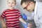 An allergist doctor makes a skin test for allergies. The boy is being examined in the laboratory, waiting for a reaction to