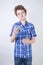 Allergy Boy Child with runny nose holding a handkerchief. Teenager is having bad health and standing on white studio background al