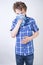 Allergy Boy Child with runny nose holding a handkerchief. Teenager is having bad health and standing on white studio background al