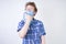 Allergy Boy Child with runny nose holding a handkerchief. Teenager is having bad health and standing on white studio background al