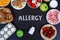 Allergy food as milk, oranges, tomatoes, garlic, shrimp, peanuts, eggs, apples, bread, strawberries on wooden table