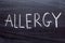 Allergy handwritten text on a black chalk Board