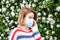 Allergy. Woman wearing protect mask from pollen allergy