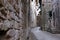 Alley of the city of Assisi with stone facades of historic houses. .Narrow alleys of the city with the walls of the stone houses.