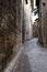 Alley of the city of Assisi with stone facades of historic houses. .Narrow alleys of the city with the walls of the stone houses.