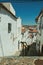 Alley going down the slope with steps among houses