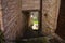 An alley of a medieval village with a tunnel under stone buildings Marche, Italy