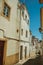 Alley with old colorful houses and deserted causeway