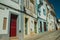 Alley of old colorful houses with worn plaster wall