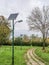 Alley in the park with lighting poles and photovoltaic panel LED lamp lights