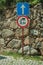 Alley with stone wall and WEIGHT LIMIT AHEAD traffic sign