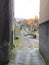 Alley surrounded by greenery buildings and a river in Borgo a Mozzano in Italy