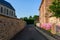 An alley in the traditional French village of Saint Sylvain in Europe, France, Normandy, Seine Maritime, in summer on a sunny day