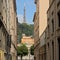 Alley with traditional houses in Lyon, with communications antenna in the background