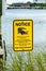 Alligator warning sign notice near water