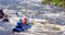 Alloy, kayaking. Two athletes sail on a rubber inflatable boat. Teamwork. Water splashes close-up.