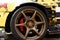 Alloy wheel with calipers and racing brakes of the sport car. Racing brake disc and low profile tyres. Race car test driving.