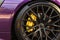 Alloy wheel with calipers and racing brakes of the sport car. Racing brake disc and low profile tyres. Race car test driving.