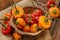 Allspice red and yellow in the wooden bowl