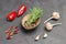 Allspice and sprigs of rosemary in a coconut shell. Dry pepper pods, fresh peppers and garlic