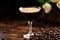 An alluring glass with a coffee-infused cocktail, elegantly resting on a dark, plush surface, epitomizing refined