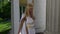 alluring greek goddess is posing near column of ancient palace at sunny windy day