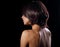 Alluring portrait of short bob hair style woman looking down on black background. Closeup portrait. Back side
