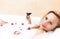 Alluring and Sensual Blond Female Relaxing in Foamy Bath Covered with Rose Petals.Drinking Red Wine