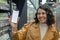 An alluring woman grips a white-screened phone in a grocery store