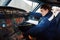 Almaty, Kazakhstan - 01.29.2014 : The service department checks the lower pedestal in the Airbus A320 aircraft of the airline