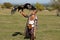 Almaty / Kazakhstan - 09.23.2020 : A teenager in a Kazakh national costume holds a tamed Golden eagle in his hands