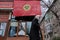 Almaty / Kazakhstan - 11.20.2020 : An elderly woman walks past a poster warning about wearing masks during quarantine  .Snowfall
