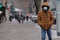 Almaty / Kazakhstan - 11.20.2020 : Masked people walk along the sidewalk in snowy weather