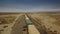 Almaty Region, Kazakhstan - October 16, 2018: The container train moves along the steppe towards the railway bridge